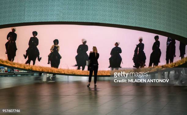 Woman looks at a 360 degrees video installation showing Don Cossacks installed at the newly built Platov Airport outside of the Southern Russian city...