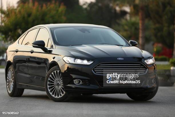 front and left side view of a mint condition black ford mondeo parked in gaziemir district of izmir - compact car stock pictures, royalty-free photos & images