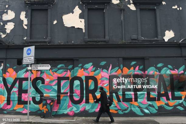 Man walks in front of a pro-choice mural urging a yes vote in the referendum to repeal the eighth amendment of the Irish constitution, a subsection...