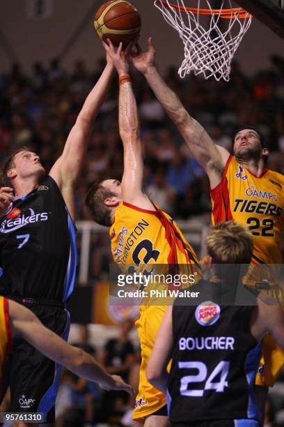 Rick Rickert of the New Zealand Breakers contests the ball with Mark Worthington and Sam MacKinnon of the Melbourne Tigers during the round 16 NBL...