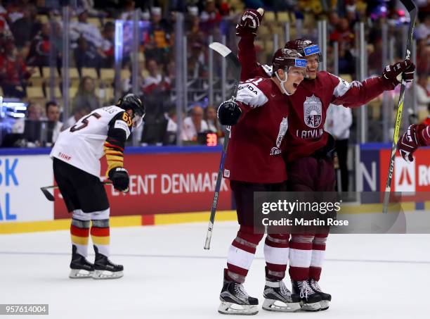 Ronalds Kenins and Ralfs Freibergs of Latvia celebrate the opening goal over Germany during the 2018 IIHF Ice Hockey World Championship Group B game...