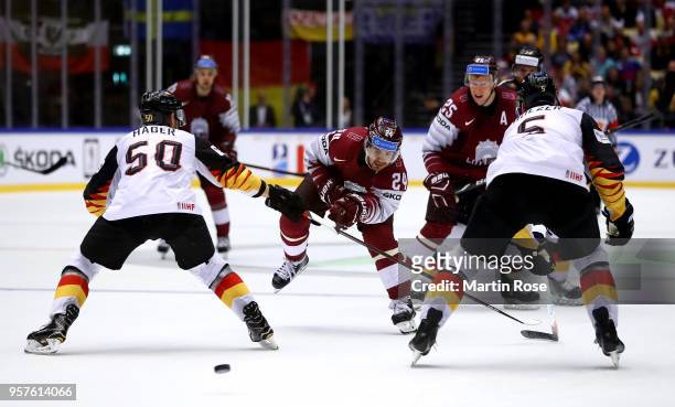 Mikelis Redlihs of Latvia fires a shot at goal during the 2018 IIHF Ice Hockey World Championship Group B game between Latvia and Germany at Jyske...
