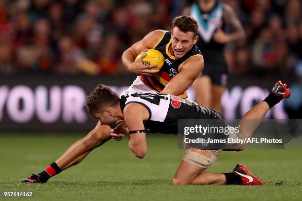 Tom Doedee of the Crows is tackled by Sam Gray of the Power during the 2018 AFL round eight match between the Port Adelaide Power and the Adelaide...