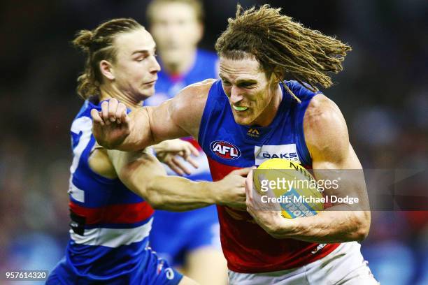 Matt Eagles of the Lions runs with the ball from Mitch Honeychurch of the Bulldogs during the round eight AFL match between the Western Bulldogs and...