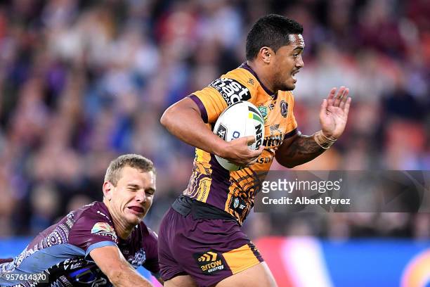 Anthony Milford of the Broncos evades the challenge from Tom Trbojevic of the Sea Eagles on his way to score a try during the round ten NRL match...