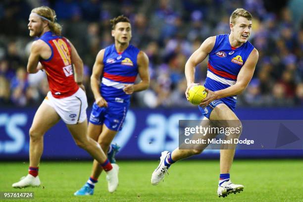 Jackson Macrae of the Bulldogs runs with the ball during the round eight AFL match between the Western Bulldogs and the Brisbane Lions at Etihad...