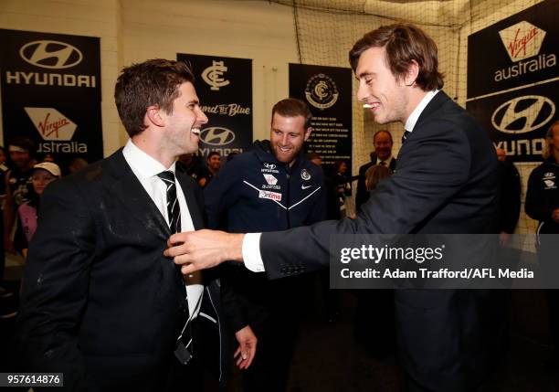 Caleb Marchbank and Sam Docherty of the Blues point out to Injured captain Marc Murphy of the Blues the gatorade on his suit from hugging players...