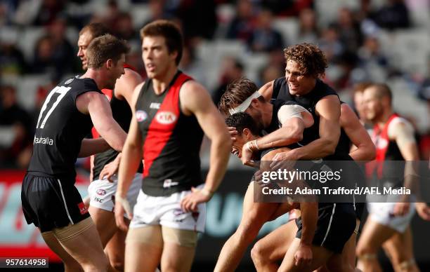 Ed Curnow of the Blues is congratulated on a great goal by Dale Thomas and Charlie Curnow of the Blues during the 2018 AFL round eight match between...