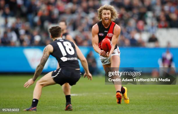 Dyson Heppell of the Bombers handpasses the ball during the 2018 AFL round eight match between the Carlton Blues and the Essendon Bombers at the...