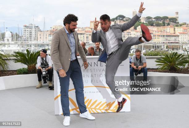 Polish director Damian Nenow and Spanish director Raul de la Fuente pose on May 12, 2018 during a photocall for the film "Another Day of Life" at the...