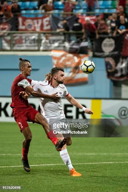 Marko Simic of Persija Jakarta is challenged by Shakir Hamzah of Home United during the AFC Cup Zonal Semi final between Home United and Persija...
