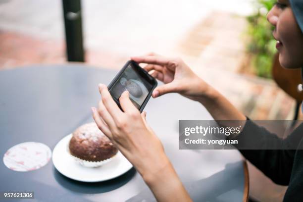 young woman taking photos of a dessert - roll call stock pictures, royalty-free photos & images