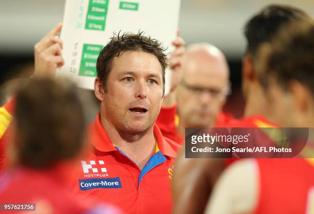 Stuart Dew, Senior Coach of the Suns talks to his team during the round eight AFL match between the Gold Coast Suns and the Melbourne Demons at The...