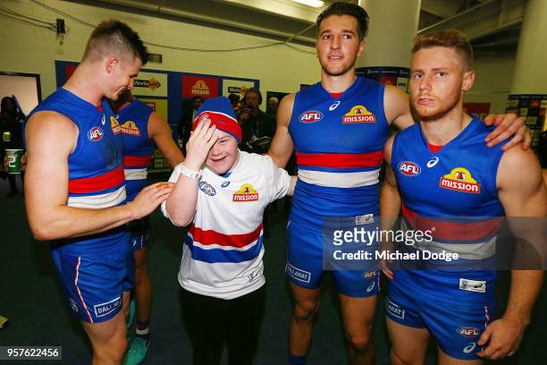 Bulldogs fan sing the club song after winning with Billy Gowers Marcus Bontempelli and Lachie Hunter of the Bulldogs during the round eight AFL match...