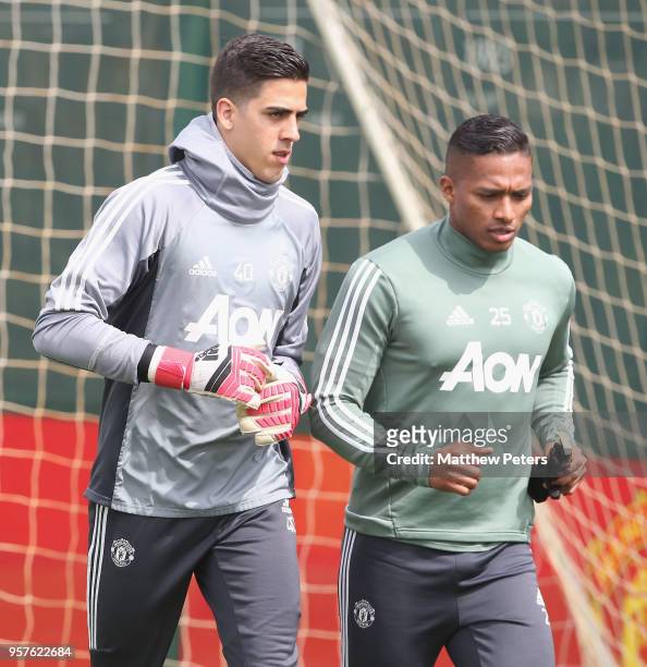 Joel Pereira and Antonio Valencia of Manchester United in action during a first team training session at Aon Training Complex on May 12, 2018 in...