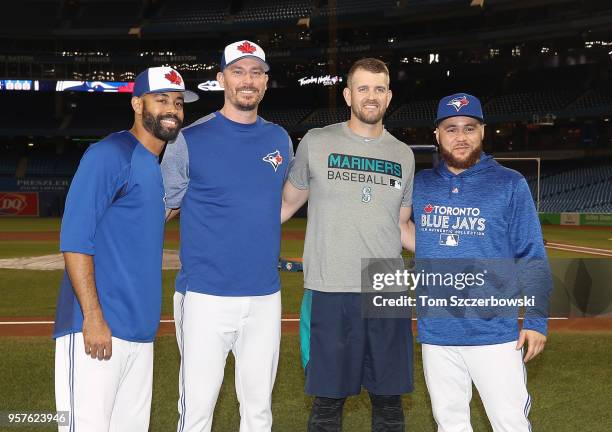 Canadian players Dalton Pompey of the Toronto Blue Jays and John Axford and Russell Martin pose with James Paxton of the Seattle Mariners a couple of...