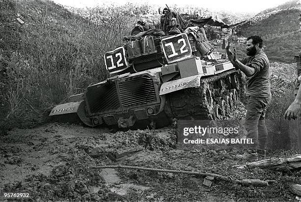 An Israeli Merkava tank is pulled out from the Awali river line when it sunk 23 January 1985. In June 1982 Israel invaded Lebanon and laid siege to...