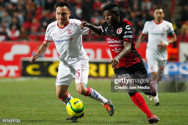 Antonio Rios of Toluca and Miler Bolanos of Tijuana fight for the ball during the semifinals first leg match between Tijuana and Toluca as part of...