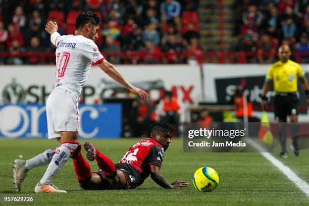 Angel Reyna of Toluca and Miler Bolanos of Tijuana fight for the ball during the semifinals first leg match between Tijuana and Toluca as part of the...