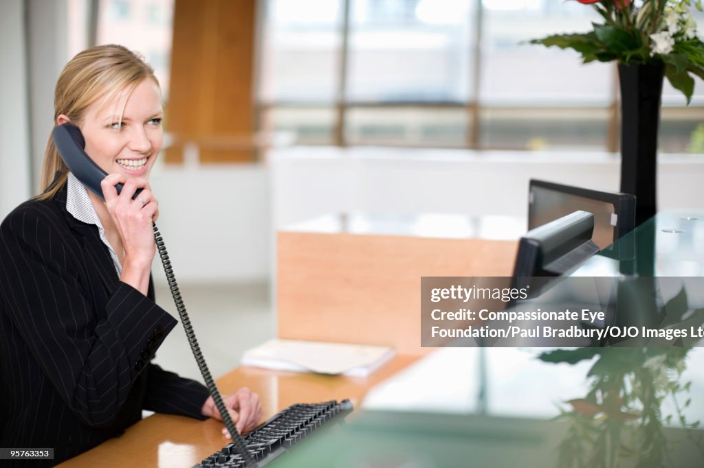 Smiling woman talking on a telephone