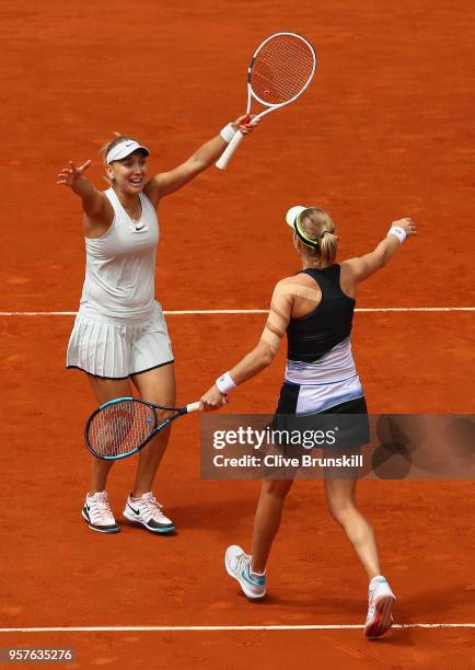 Elena Vesnina and Ekaterina Makarova of Russia celebrate match point against Timea Babos of Hungry and Kristina Mladenovic of France in the womens...