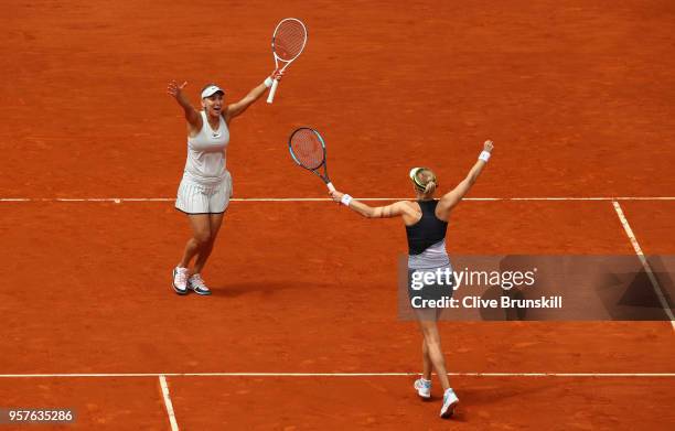 Elena Vesnina and Ekaterina Makarova of Russia celebrate match point against Timea Babos of Hungry and Kristina Mladenovic of France in the womens...