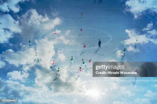 Multi layered, boys playing soccer game in the cloud