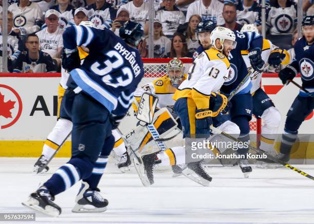 Nick Bonino of the Nashville Predators turns as he tries to block the shot off the point from Dustin Byfuglien of the Winnipeg Jets during first...