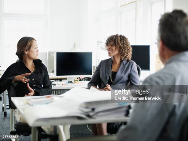 three colleagues in discussion in office - leanintogether stock pictures, royalty-free photos & images