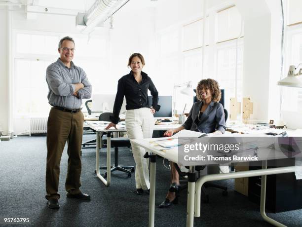 portrait of three coworkers in office - three people portrait stock pictures, royalty-free photos & images