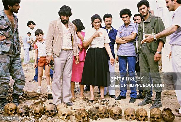 Amal Shi'ite militiamen and Muslim villagers display 08 May 1985 in the Christian-Muslim village of Jiyeh, near Saida the sculls and rotting corpses...