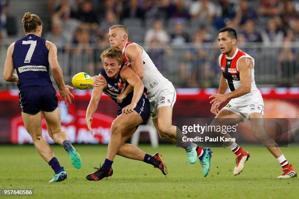Sebastian Ross of the Saints tackles Mitchell Crowden during the round eight AFL match between the Fremantle Dockers and the St Kilda Saints at Optus...