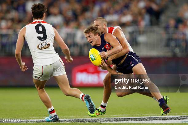 Sebastian Ross of the Saints tackles Mitchell Crowden during the round eight AFL match between the Fremantle Dockers and the St Kilda Saints at Optus...