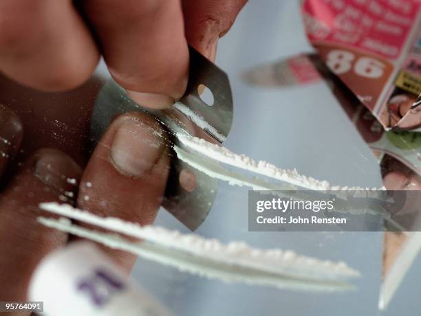 hand cutting cocaine lines on a mirror - cutting cocaine stock pictures, royalty-free photos & images