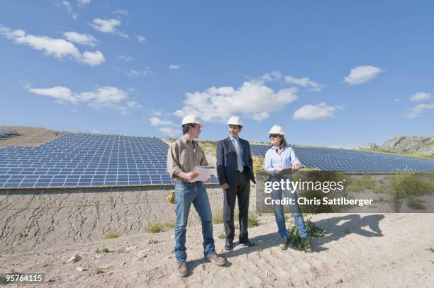 engineers and businessman in solar plant  - chris sattlberger stock pictures, royalty-free photos & images