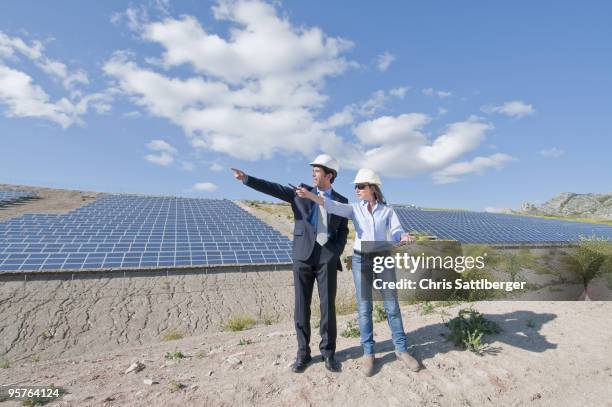 engineer and businessman in solar plant - chris sattlberger stock pictures, royalty-free photos & images