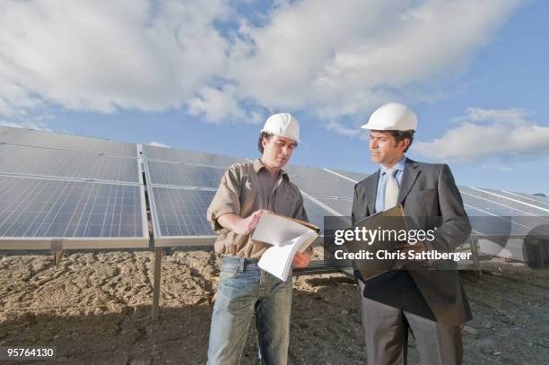engineer and businessman in solar plant - chris sattlberger stock pictures, royalty-free photos & images