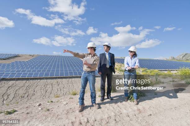 engineers and businessman in solar plant - chris sattlberger stock pictures, royalty-free photos & images