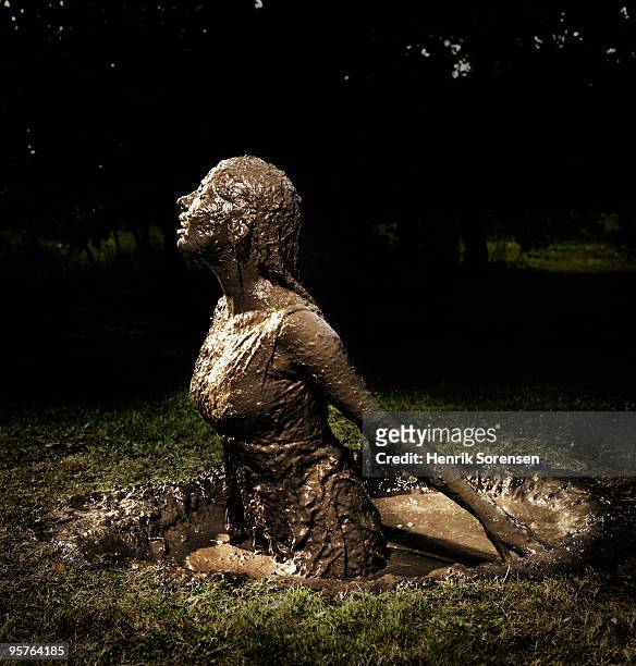 woman emerging from a mud hole - emerging from ground stock pictures, royalty-free photos & images