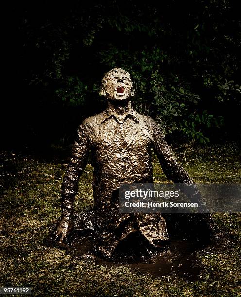 businessman emerging from a mud hole - emerging from ground stock pictures, royalty-free photos & images