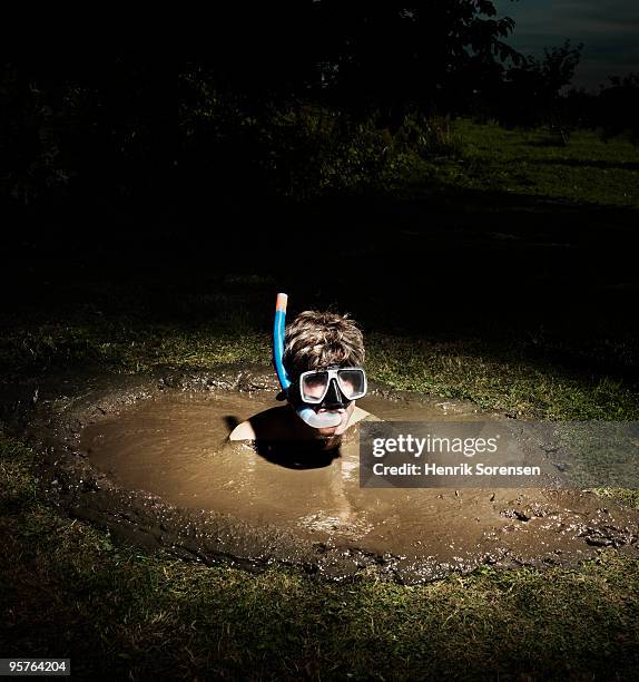 adult male diver with snorkel in a mud hole - quicksand stock pictures, royalty-free photos & images