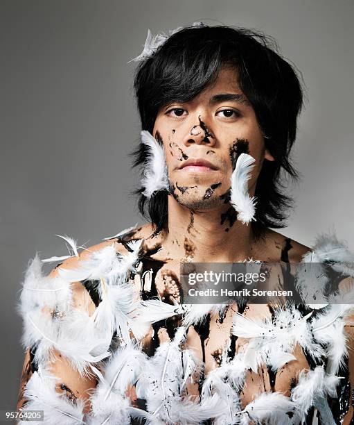 young adult male covered in tar and feathers - tar and feather photos et images de collection