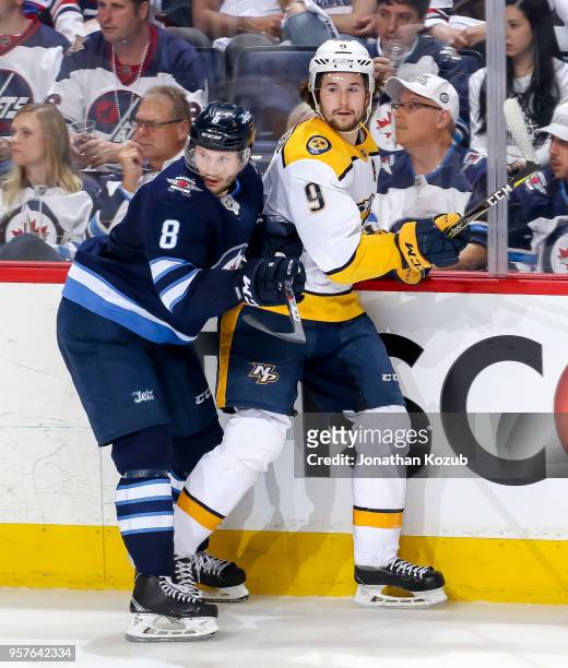 Jacob Trouba of the Winnipeg Jets and Filip Forsberg of the Nashville Predators keep an eye on the play during second period action in Game Six of...