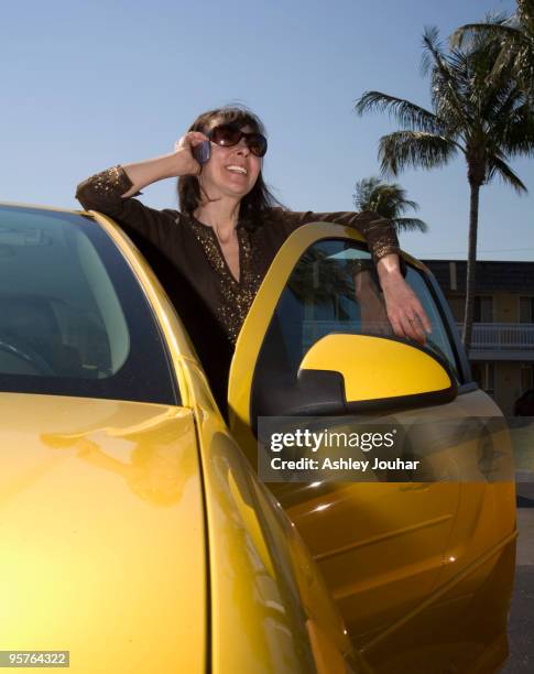 woman (40-45) on cell phone by car - ashley jouhar imagens e fotografias de stock