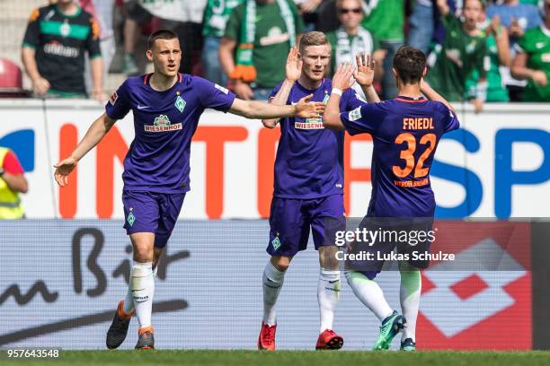 Maximilian Eggestein , scorer Florian Kainz and Marco Friedl of Bremen celebrate their teams first goal during the Bundesliga match between 1. FSV...