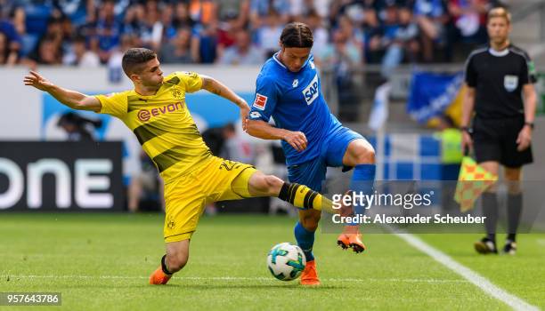 Christian Pulisic of Dortmund challenges Nico Schulz of Hoffenheim during the Bundesliga match between TSG 1899 Hoffenheim and Borussia Dortmund at...
