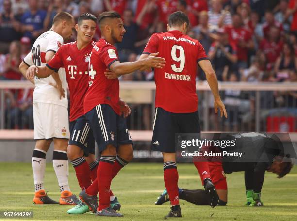 Tolisso of Bayern Muenchen celebrates with James Rodriguez of Bayern Muenchen and Robert Lewandowski of Bayern Muenchen after he scored a goal to...