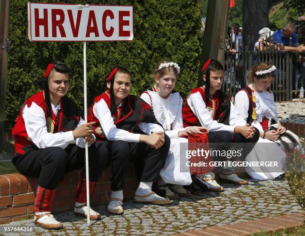 Participants in traditional costumes attend a commemoration rally at the Loibacher Feld in Bleiburg, Austria, on May 12, 2018. - The participants...