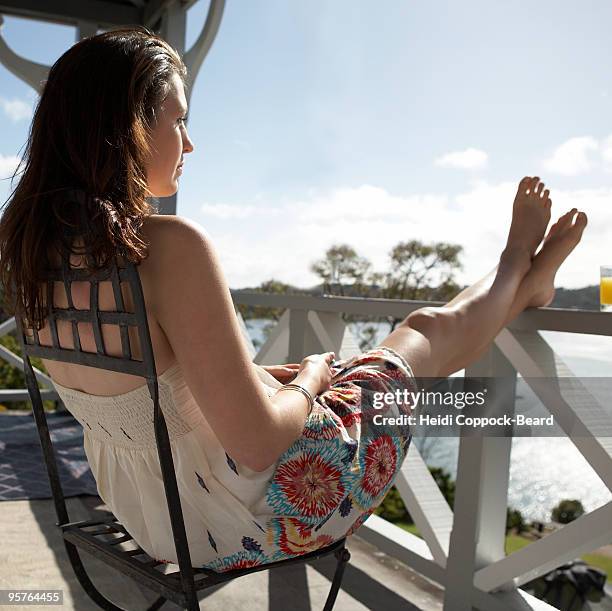 woman relaxing on balcony  - heidi coppock beard stock pictures, royalty-free photos & images