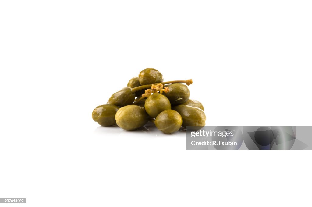 Heap of canned capers on a white background